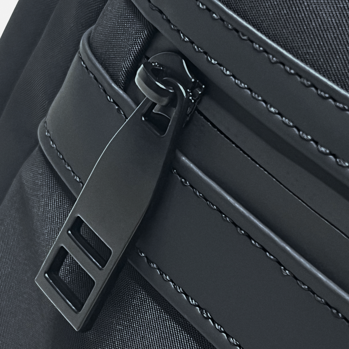 Aries Backpack — Black - Aries front zipper pocket close-up